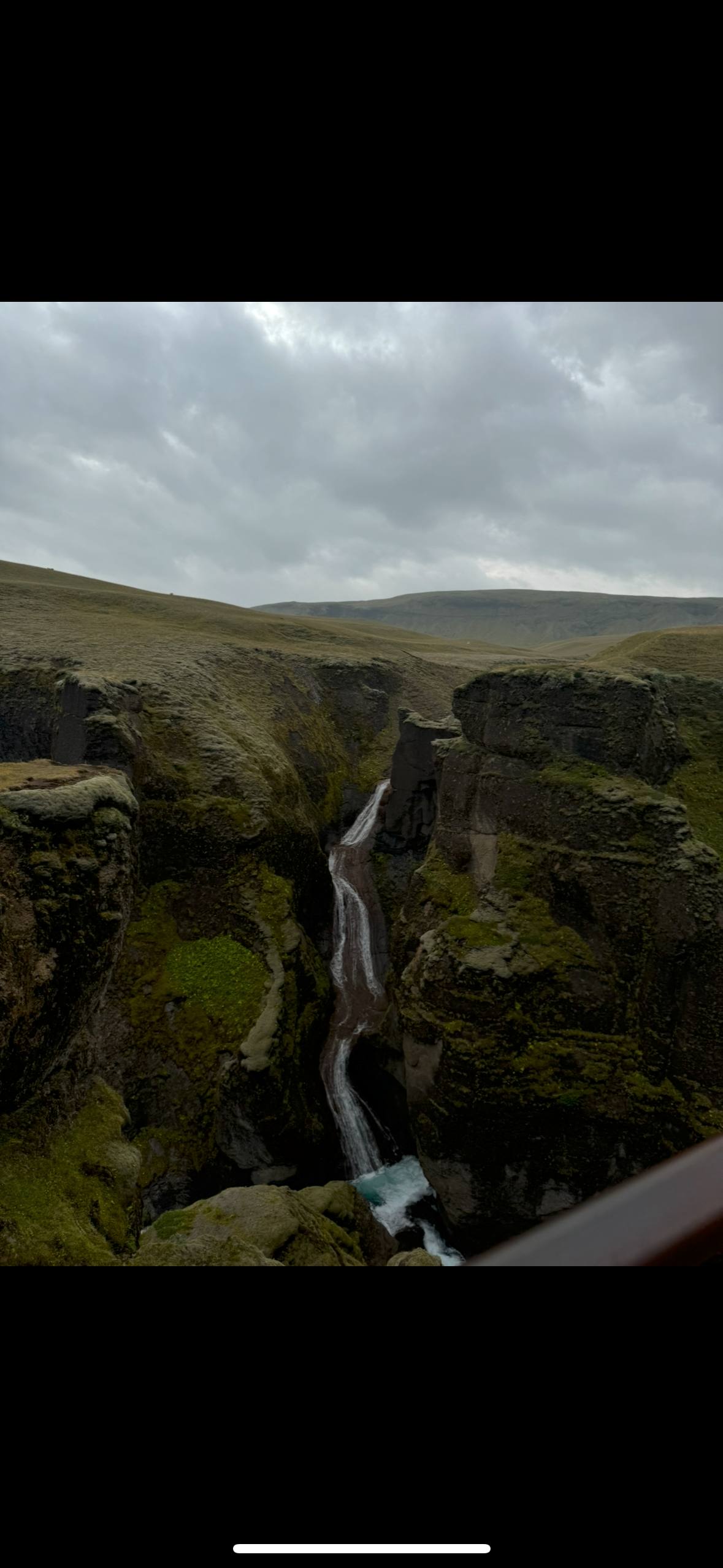Waterfall flowing through a rocky canyon